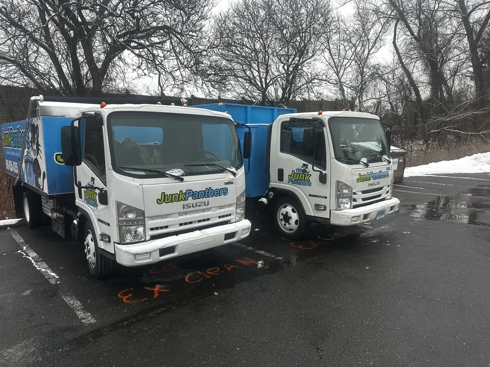 Two Junk Panthers trucks parked side by side in winter